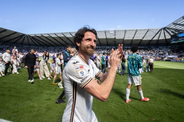Joe Allen applauds after his final game as a player at the end of last season