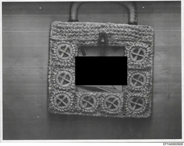 A photo frame with a black bar over it.