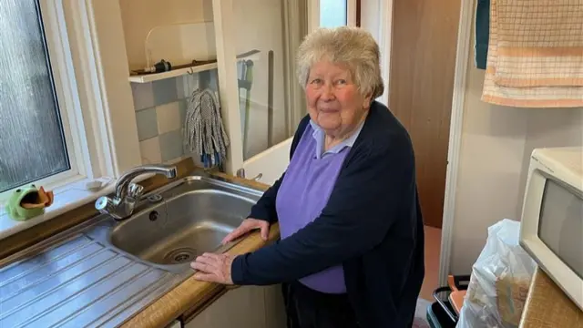 Elderly woman at her sink