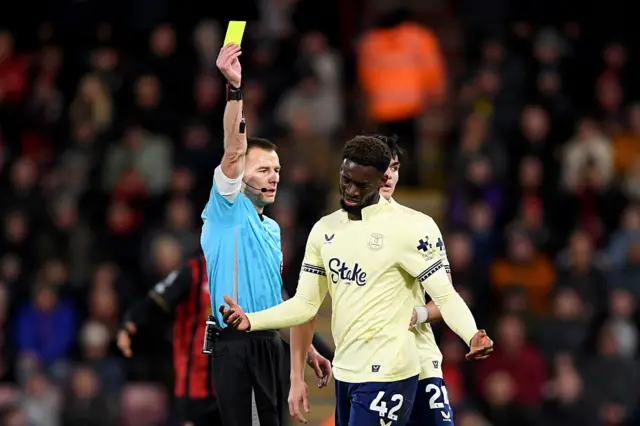 Tim Iroegbunam is shown a yellow card