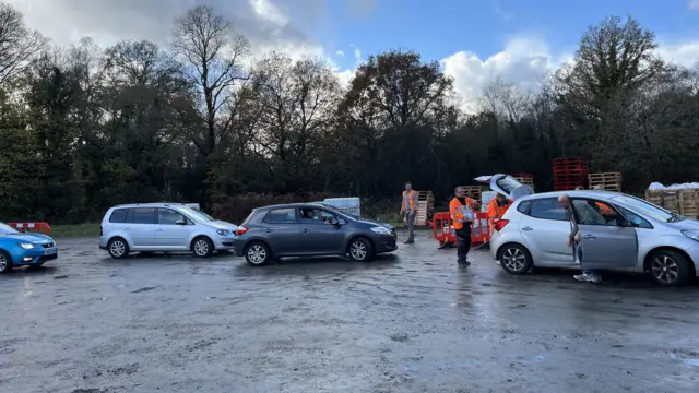 Cars in a car pack loading water