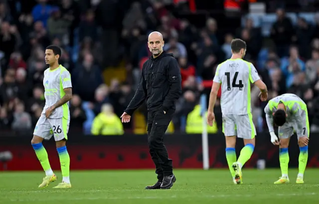 Pep Guardiola reacts at Villa Park