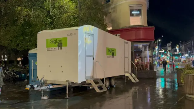 Portaloos outside of a shop.