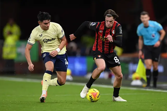 Alex Scott and Carlos Alcaraz challenge for the ball