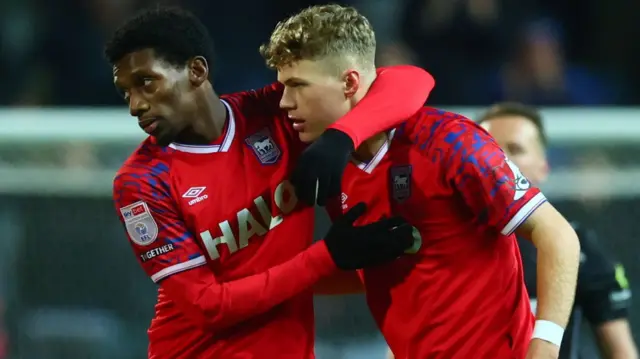 Sindre Walle Egeli is hugged by team-mate Jaden Philogene