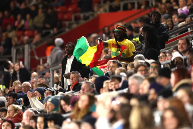 Ghana fans in the stand wave flags during the women's international friendly at St. Mary's Stadium, Southampton.