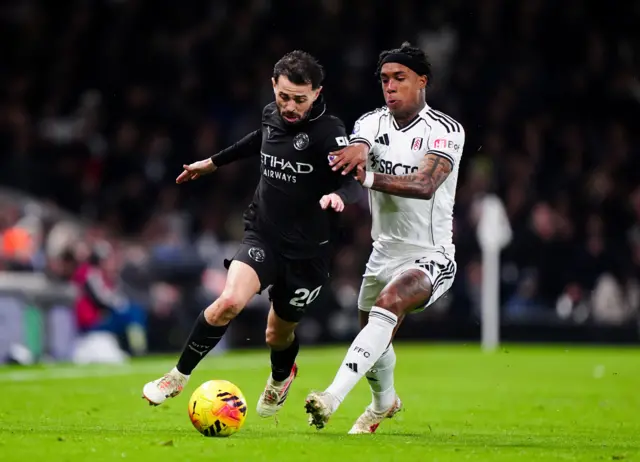 Kevin and Bernardo Silva tussle for the ball