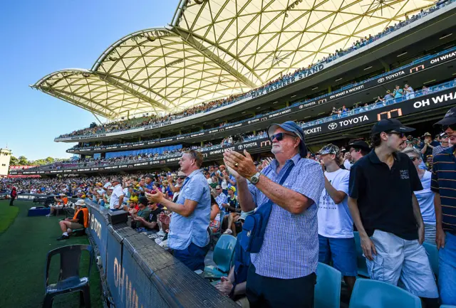 Fans at the Adelaide Oval applaud Travis Head