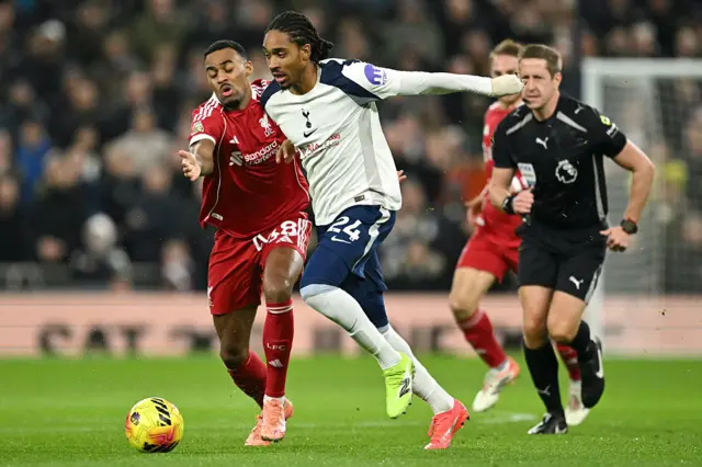 Tottenham Hotspur's English defender #24 Djed Spence (R) holds off Liverpool's Dutch midfielder #38 Ryan Gravenberch (L) during the English Premier League football match between Tottenham Hotspur and Liverpool at the Tottenham Hotspur Stadium in London, on December 20, 2025.