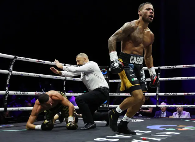 The referee stops Callum Simpson from getting up, Troy Williamson celebrates