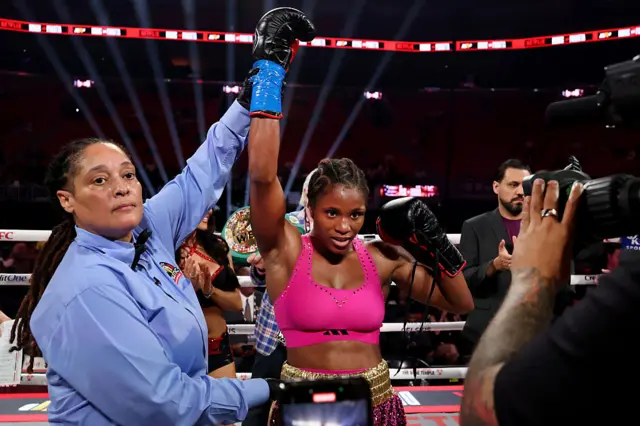 Caroline Dubois has her hand raised