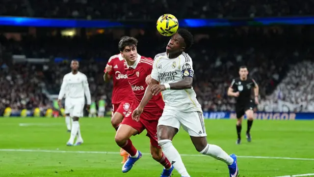 Vinicius Junior of Real Madrid is put under pressure by Juanlu Sanchez of Sevilla FC