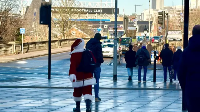 A fan in a Father Christmas suit on his way to Portman Road