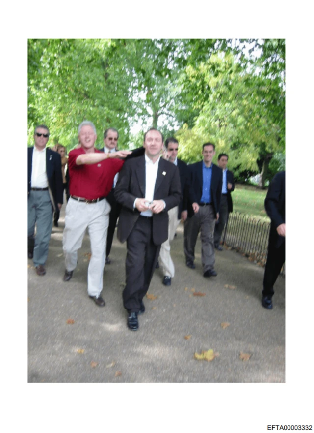 Actor Kevin Spacey and former US president Bill Clinton appear to be pictured walking through a park, with other men behind them
