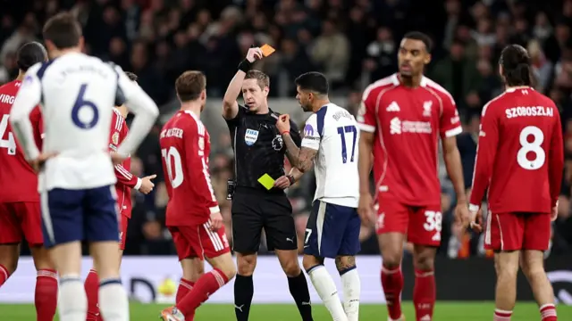 Cristian Romero of Tottenham Hotspur receives a second yellow card
