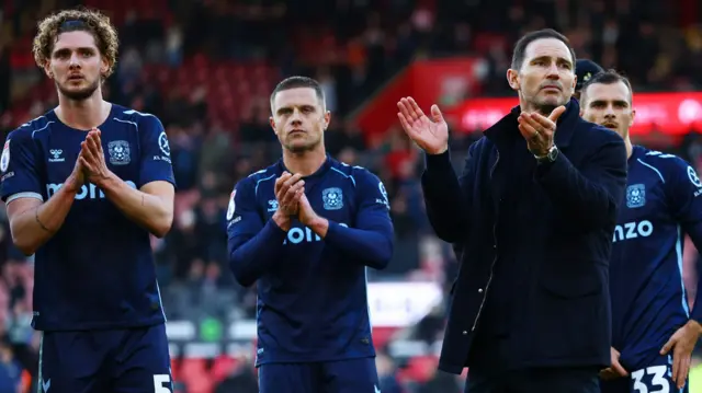 Coventry boss Frank Lampard and three players clap their fans at the end of their game with Southampton