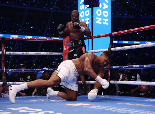 Daniel Dubois stands as Anthony Joshua goes down during their IBF World Heavyweight Title fight