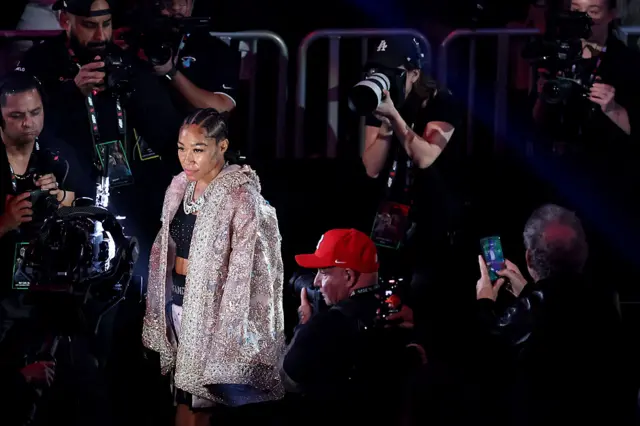 Alycia Baumgardner walks to the ring in a sequence coat