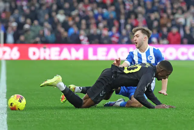 Nordi Mukiele of Sunderland (L) is tackled by Jack Hinshelwood of Brighton during the Premier League match between Brighton & Hove Albion and Sunderland at Amex Stadium on December 20, 2025 in Brighton, United Kingdom.