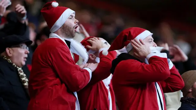 Middlesbrough fans, dressed as Father Christmas, react to a missed chance against Bristol City