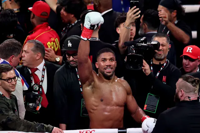 Anthony Joshua celebrates with his glove in the air