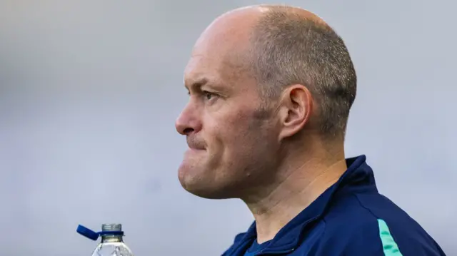 Millwall boss Alex Neil looking pensive and holding an open water bottle
