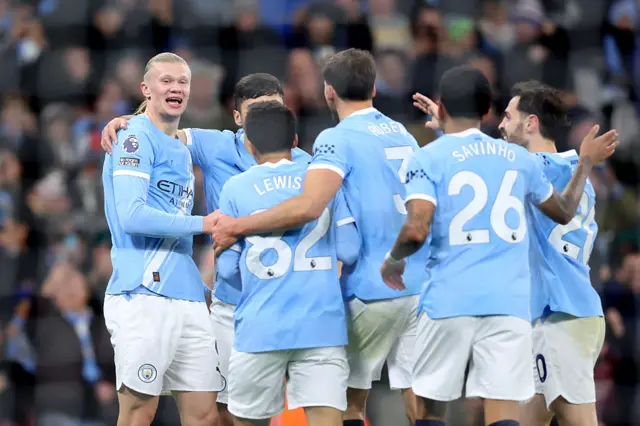 Erling Haaland of Manchester City (L) celebrates scoring his team's third goal