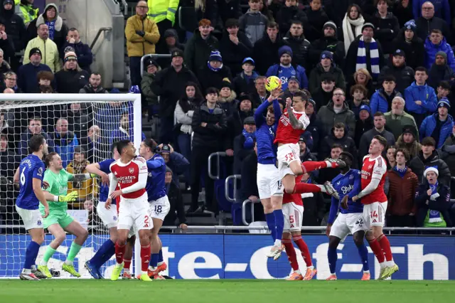 Jake O'Brien of Everton battles for an aerial ball against Riccardo Calafiori of Arsenal, which results in a hand ball and penalty to Arsenal, during the Premier League match between Everton and Arsenal at Hill Dickinson Stadium.