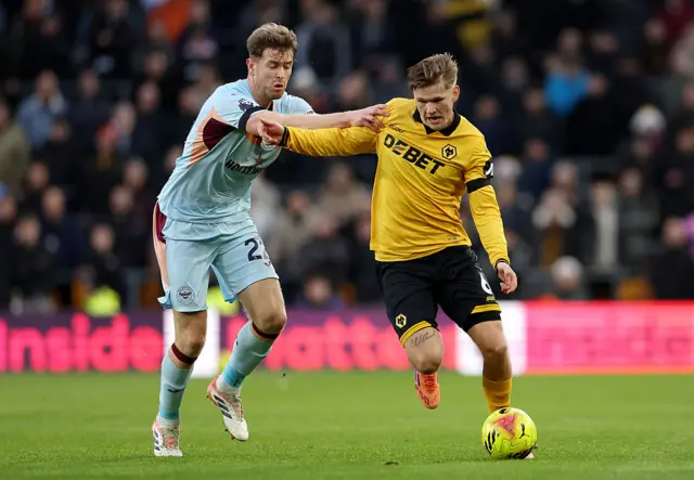 David Moller Wolfe of Wolverhampton Wanderers runs with the ball whilst under pressure from Nathan Collins of Brentford during the Premier League match between Wolverhampton Wanderers and Brentford at Molineux on December 20, 2025