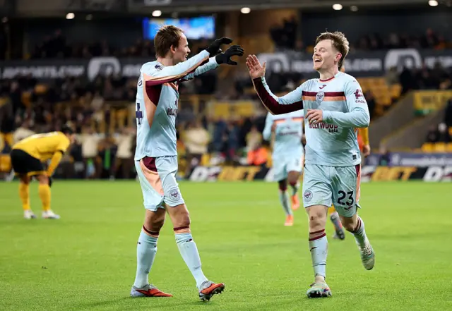 Keane Lewis-Potter of Brentford celebrates scoring his team's second goal with teammate Mikkel Damsgaard during the Premier League match between Wolverhampton Wanderers and Brentford at Molineux on December 20, 2025 in Wolverhampton, England.