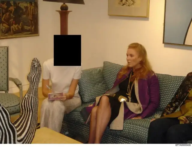 Sarah Fergusonsat on a sofa, woman next to her with face covered by a black square.
