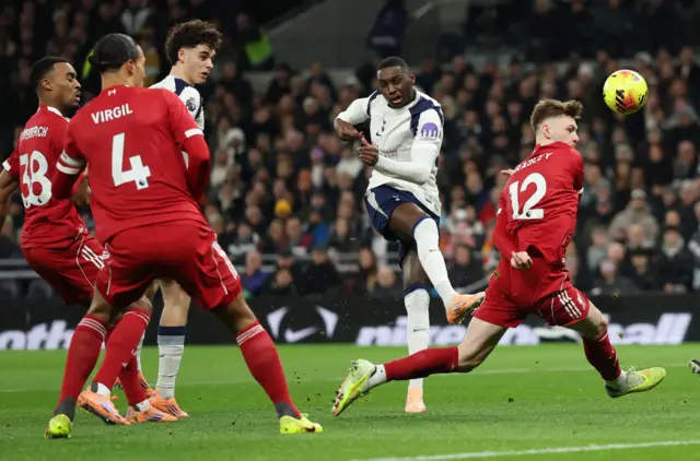 Liverpool's Conor Bradley in action as Tottenham Hotspur's Randal Kolo Muani shoots at goal