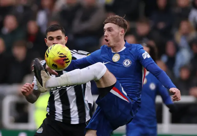 Newcastle United's Bruno Guimaraes in action with Chelsea's Cole Palmer.