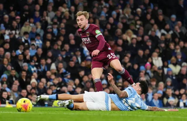West Ham United's Jarrod Bowen gets past Manchester City's Nico O'Reilly (right) during the Premier League match at the Etihad Stadium, Manchester