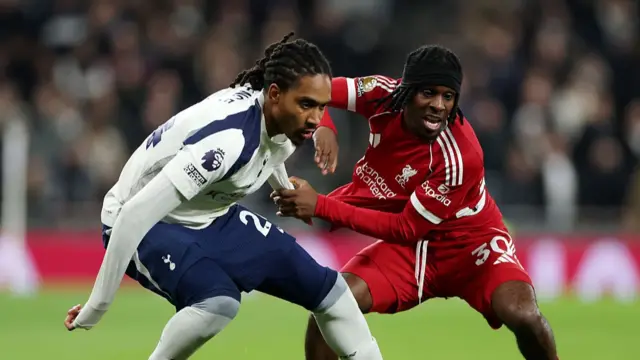 Djed Spence of Tottenham Hotspur battles for possession with Jeremie Frimpong of Liverpool during the Premier League match between Tottenham Hotspur and Liverpool at Tottenham Hotspur Stadium