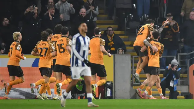 Hull players mob goalscorer Oli McBurnie