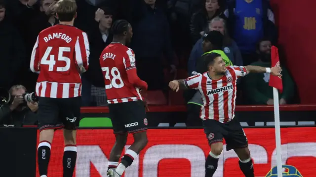 Gus Hamer celebrates by the corner flag after scoring against Birmingham