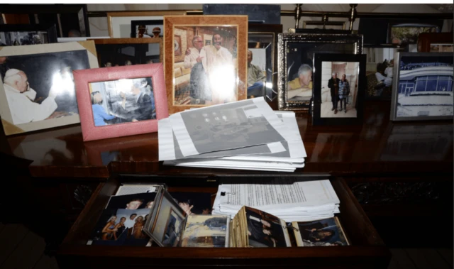 An image of lots of framed photos on the desk is released as part of the latest batch of the Epstein files
