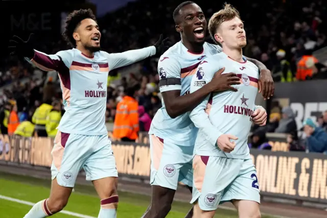 Brentford's Keane Lewis-Potter celebrates scoring with Kevin Schade and Michael Kayode during the Premier League match at the Molineux Stadium, Wolverhampton.