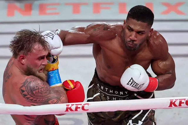 Anthony Joshua lands a punch on Jake Paul