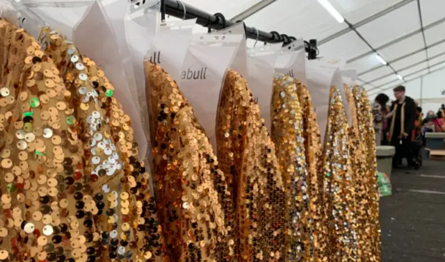 Sequin costumes on a clothes rail