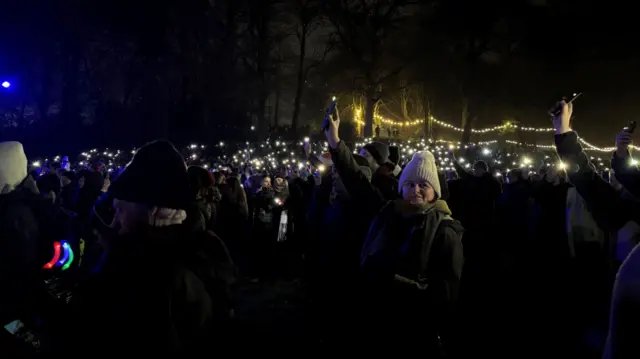 The audience shine their phones