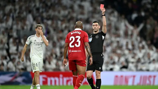 Marcao of Sevilla FC is shown a red card by referee, Alejandro Muniz,