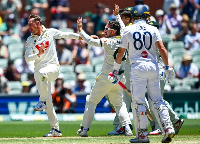 Marnus Labuschagne of Australia celebrates after catching the wicket of Ollie Pope of England with Travis Head of Australia during day four of the Third Test Match in the 2025-26 Ashes Series between Australia and England at Adelaide Oval