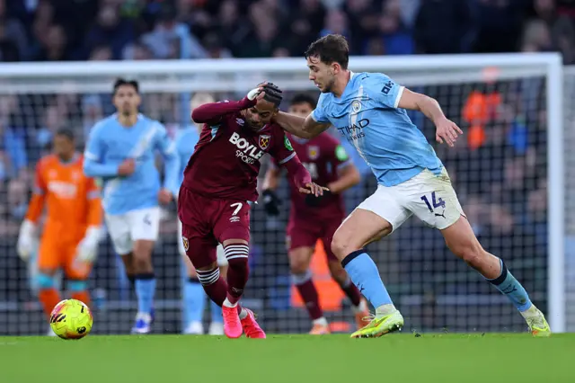 Crysencio Summerville of West Ham United is challenged by Nico Gonzalez of Manchester City