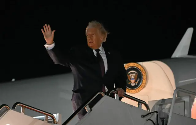Donald Trump waves on the steps of Air Force One