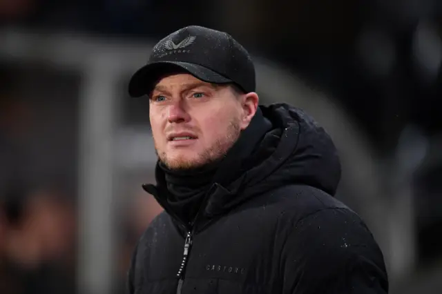 Kim Hellberg, wearing a cap, watching Middlesbrough play