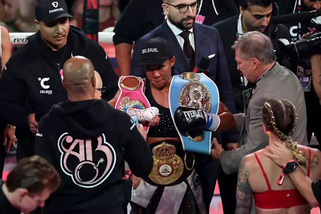 Alycia Baumgardner with her world titles in the ring