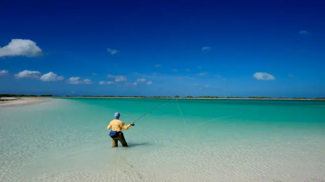 Man fly-fishing in sea, Kiribati
