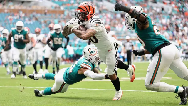 Chase Brown of the Cincinnati Bengals dives for a touchdown against the Miami Dolphins